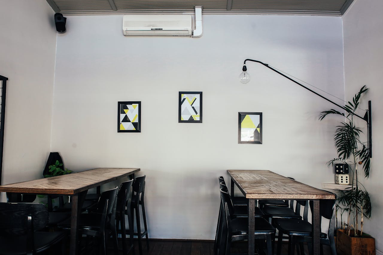Room with tables and chairs. Image by Pexels