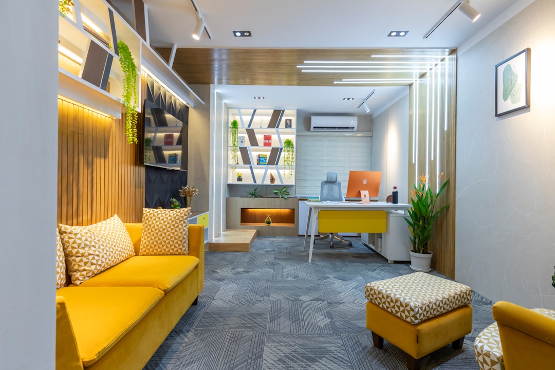 Modern office with yellow sofa, air-conditionin on wall. Image by Unsplash