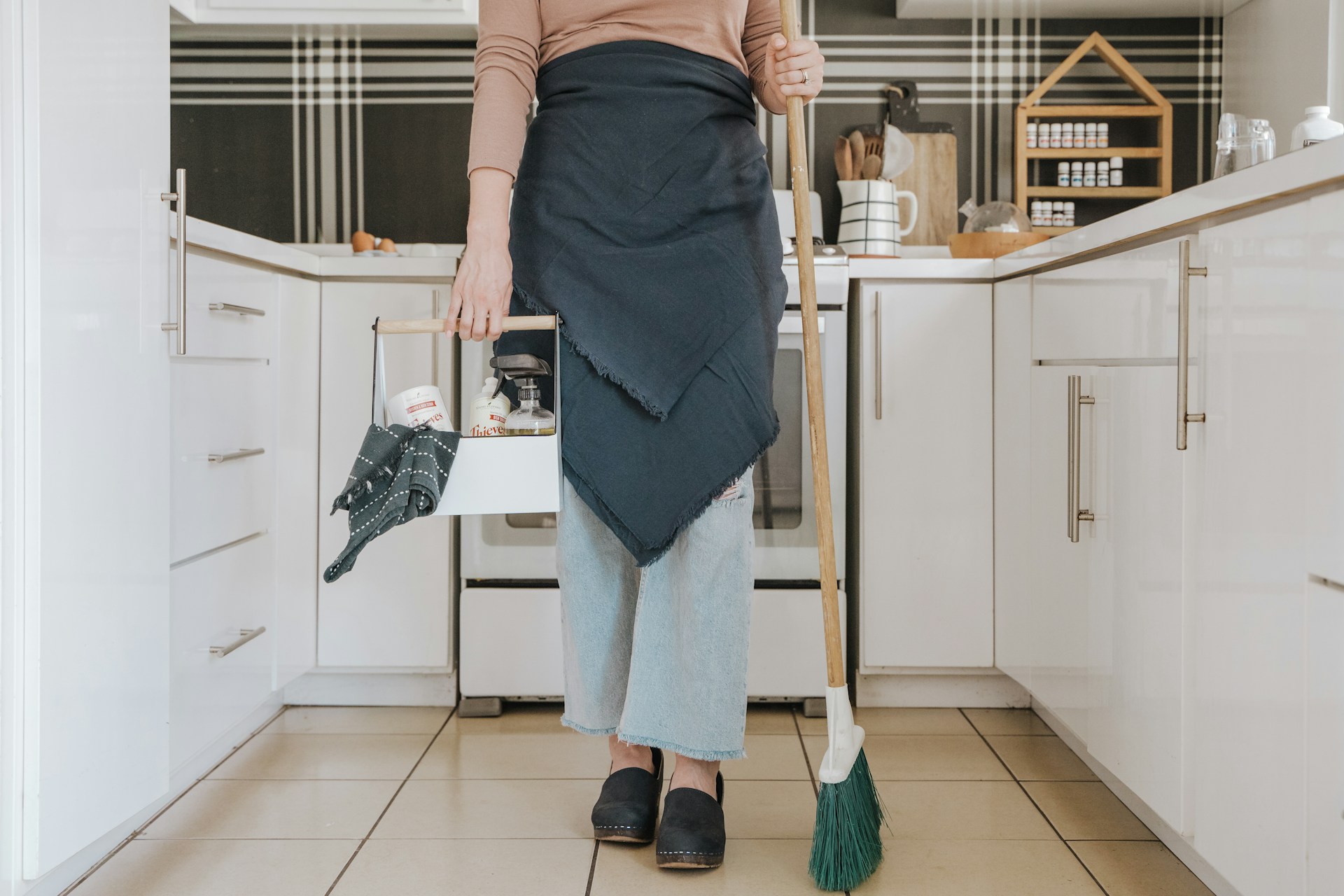 Person with cleaning supplies. Image by Unsplash