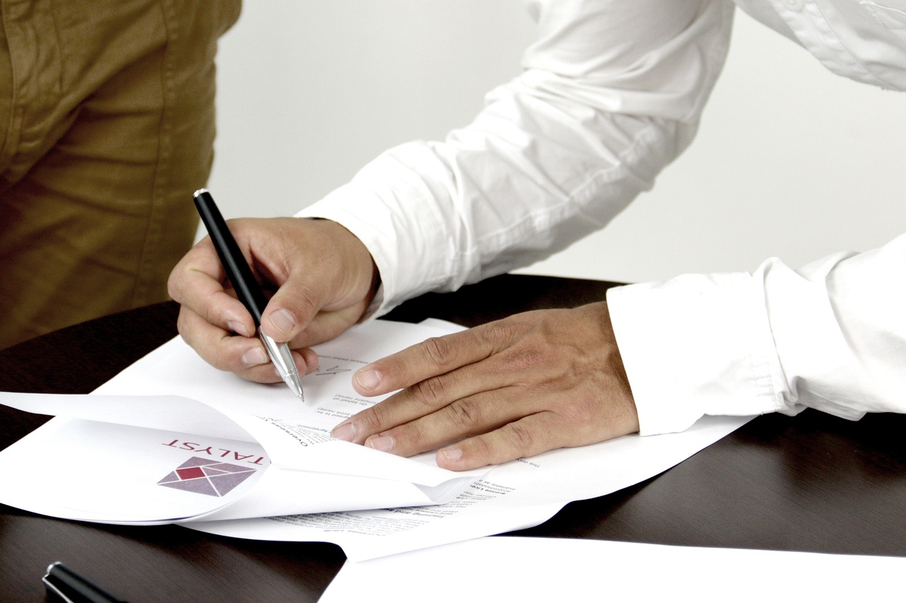 Person signing a contract. Image by Pixabay