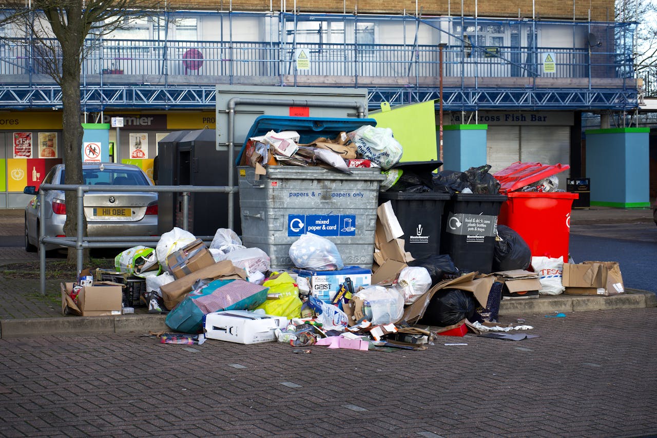 A pile of trash in an urban area. Image by Pexels