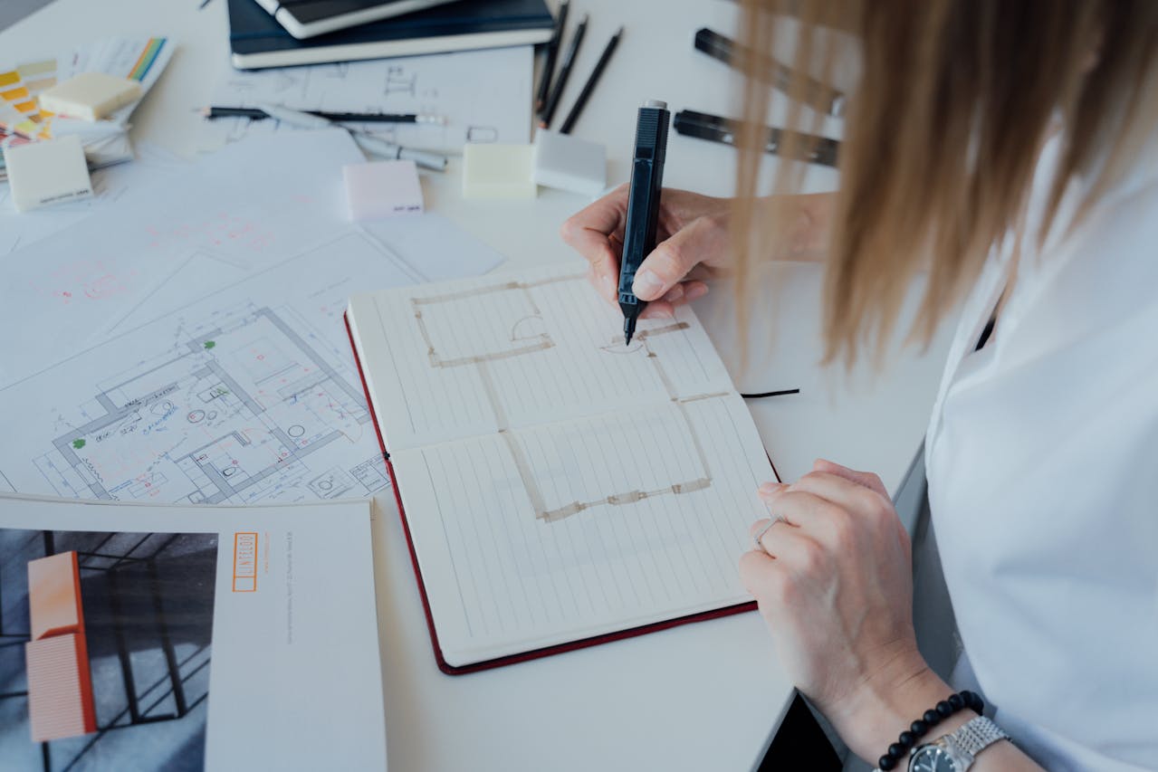 Architect working on a floor plan. Image by Pexels