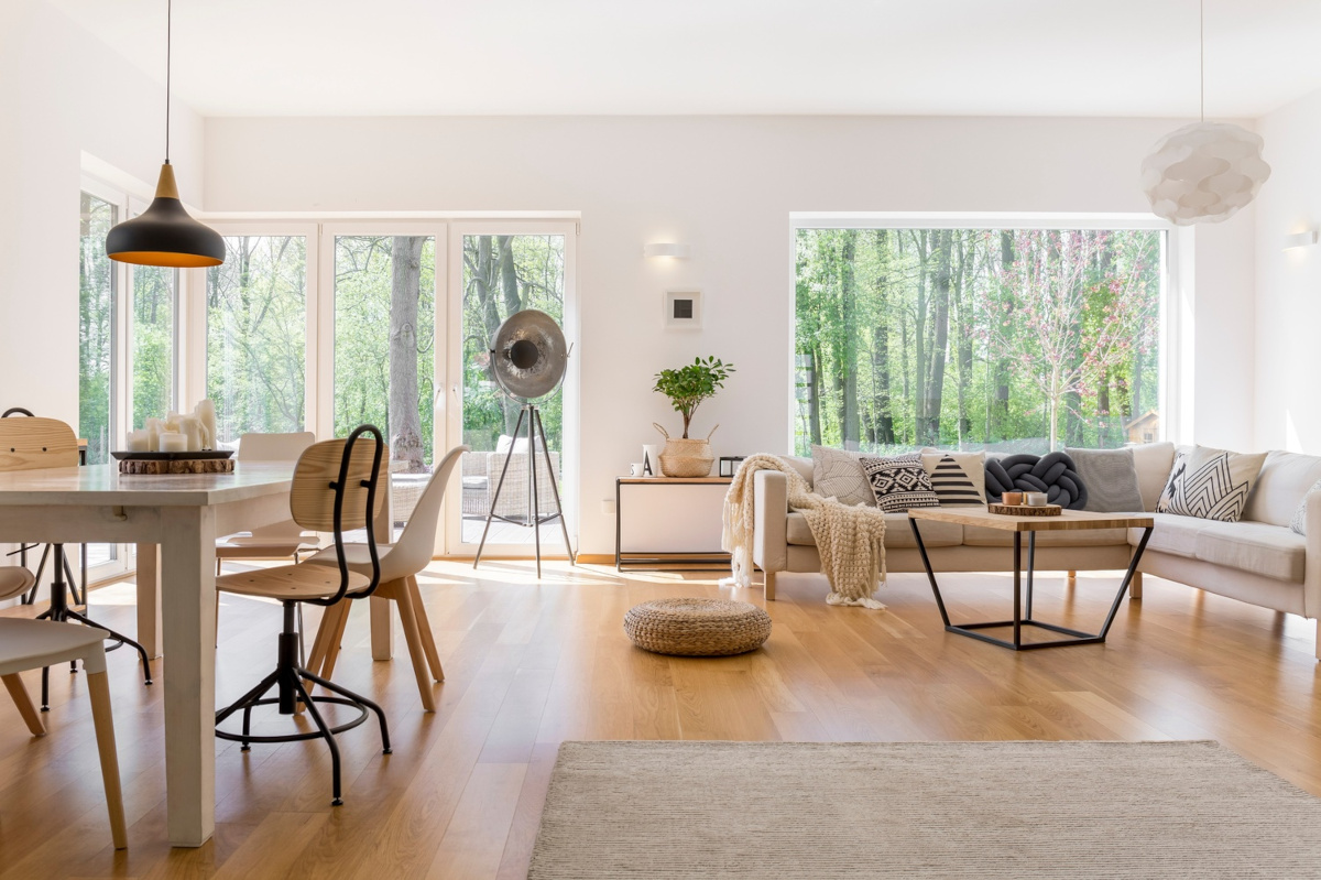 open layout livingroom with large windows and a dining area