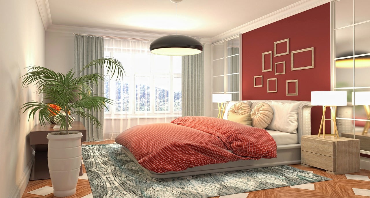 Bedroom with red wall, large window.
