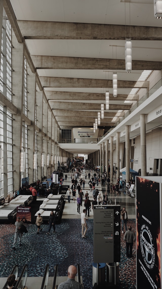 People inside a building, high ceiling. Image by Unsplash
