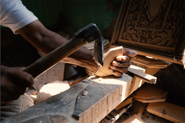 A person working on a piece of wood. Image by Unsplash