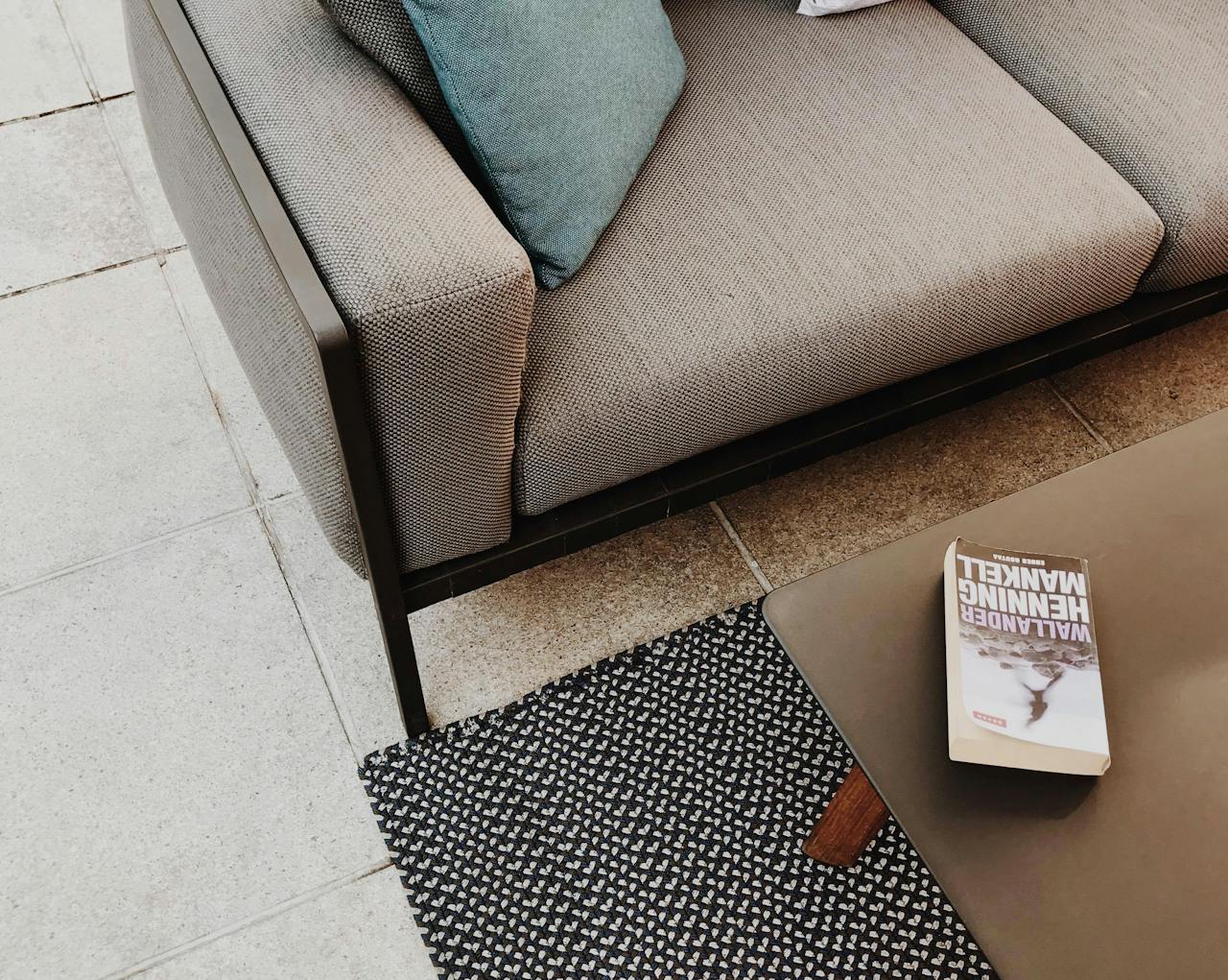 white and brown book on a table near a couch. Image by Pexels