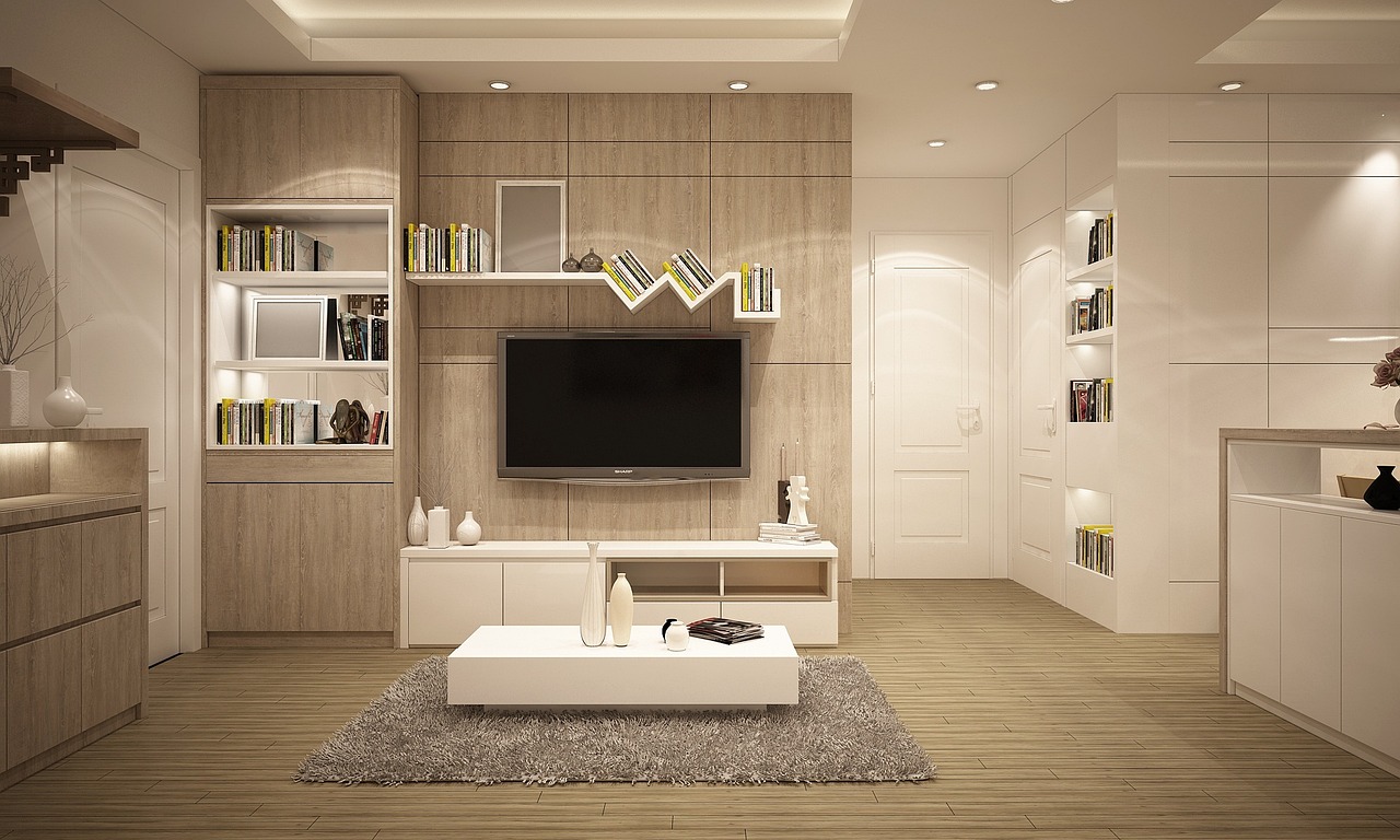 Livingroom with TV on wall, books on shelves. Image by Pixabay
