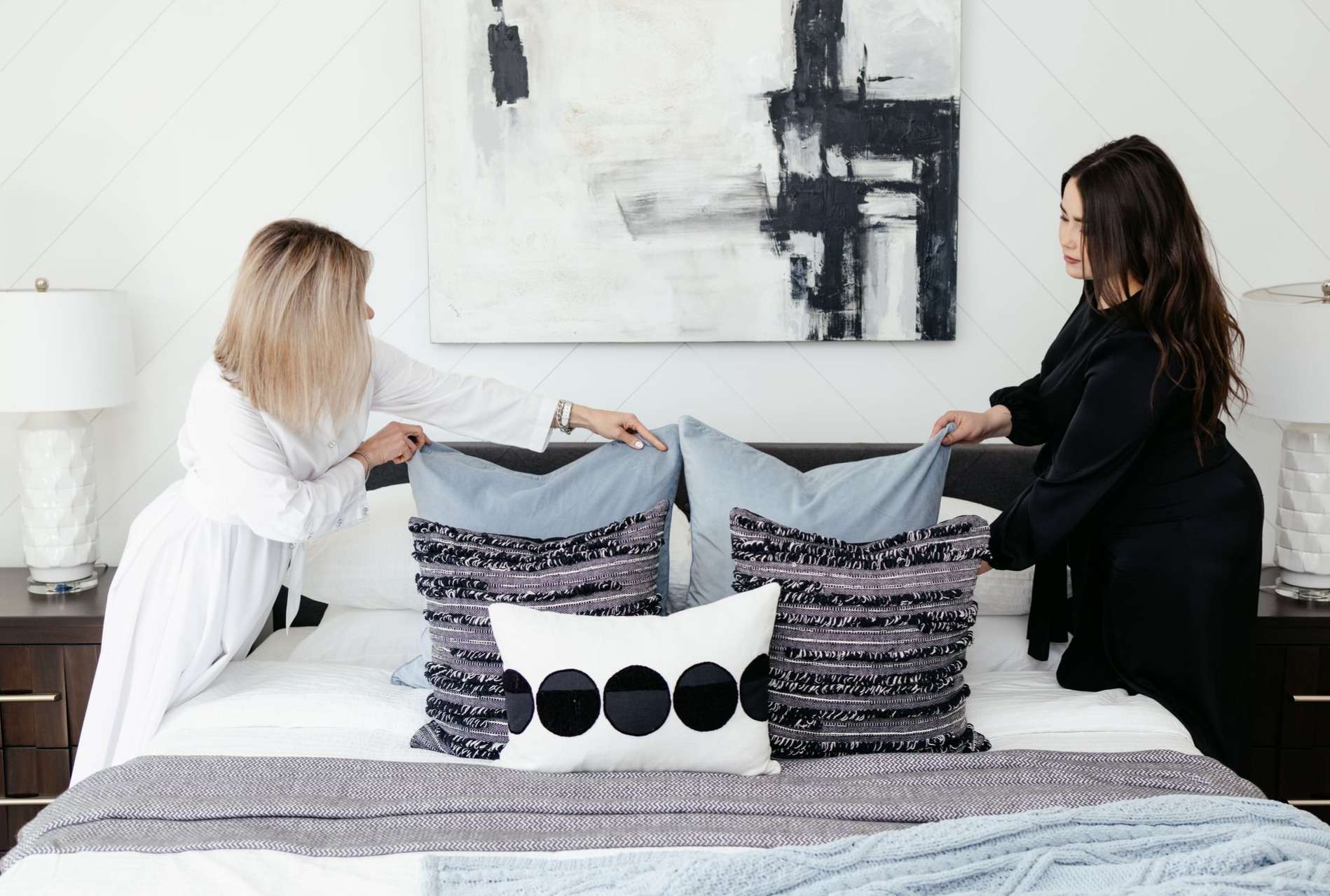 Person making a bed.