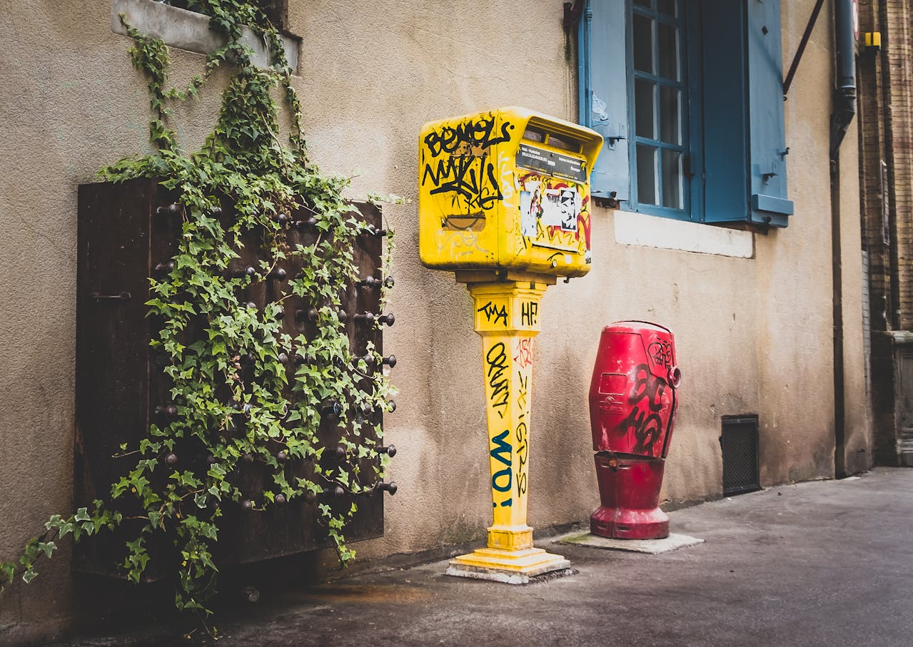 Yellow mailbox, white house. Image by Pexels