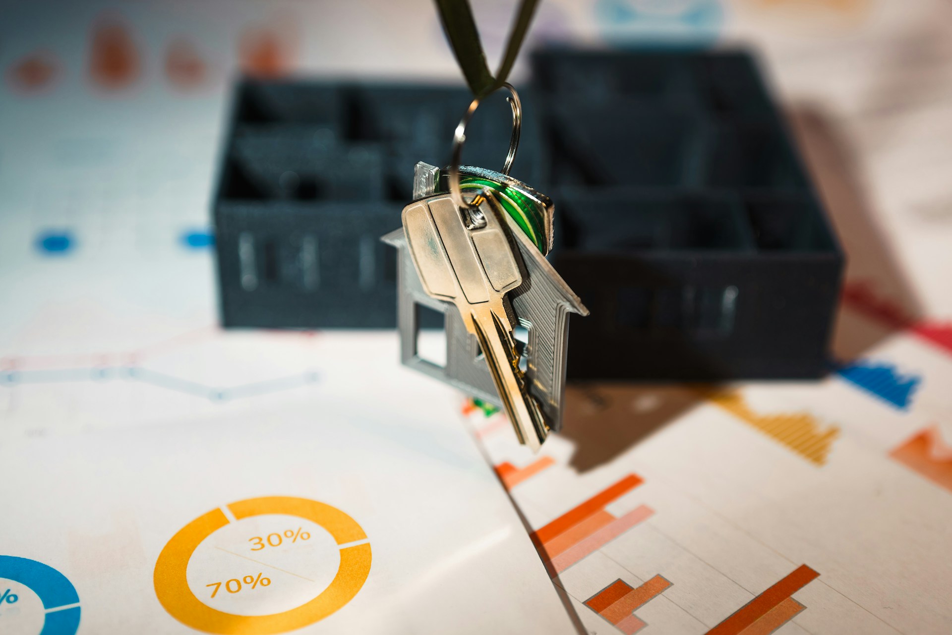 A room with a ceiling that has been torn offKey hanging from a house shaped keychain. Image by Unsplash