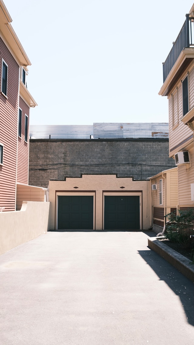 Apartment buildings, two car garage. Image by Unsplash