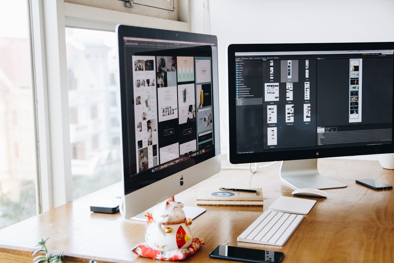 Two computers on a desk. Image by Pexels