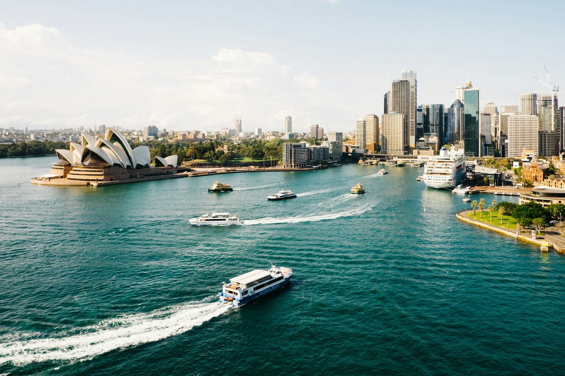 Sydney Opera house, ocean, high rise buildings. Image by Unsplash