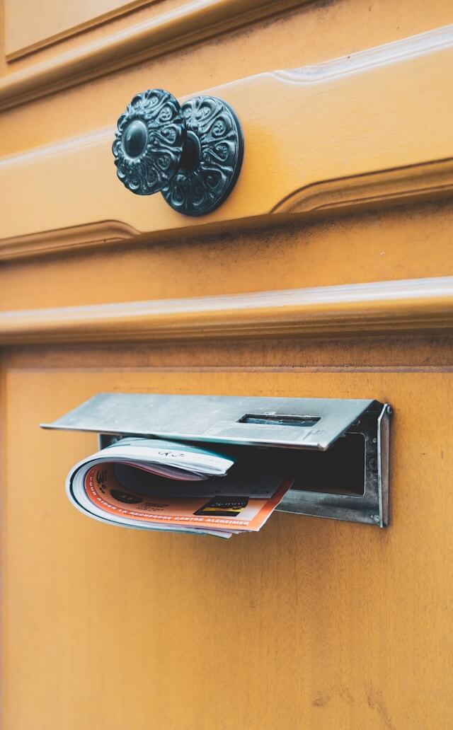 Brochure in a mail slot. Image by Unsplash