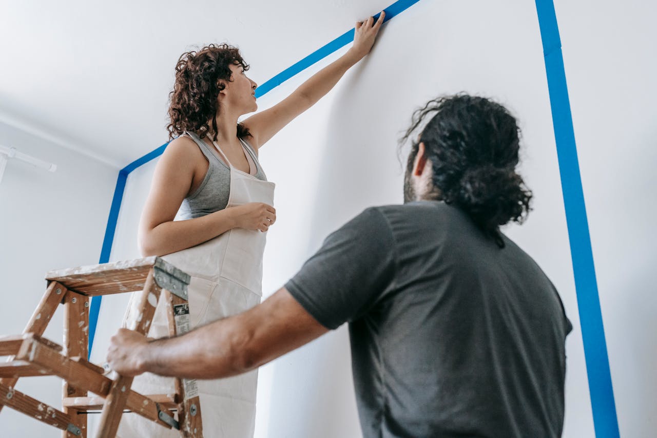 Person sanding a ceiling. Image by Pexels
