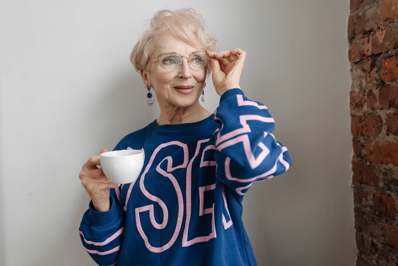 Person in a white shirt holding a cellphone. Image by Pexels