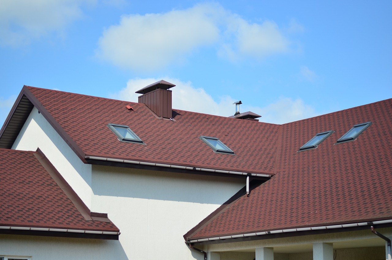 red roof tiles on a white house. Image by Pixabay