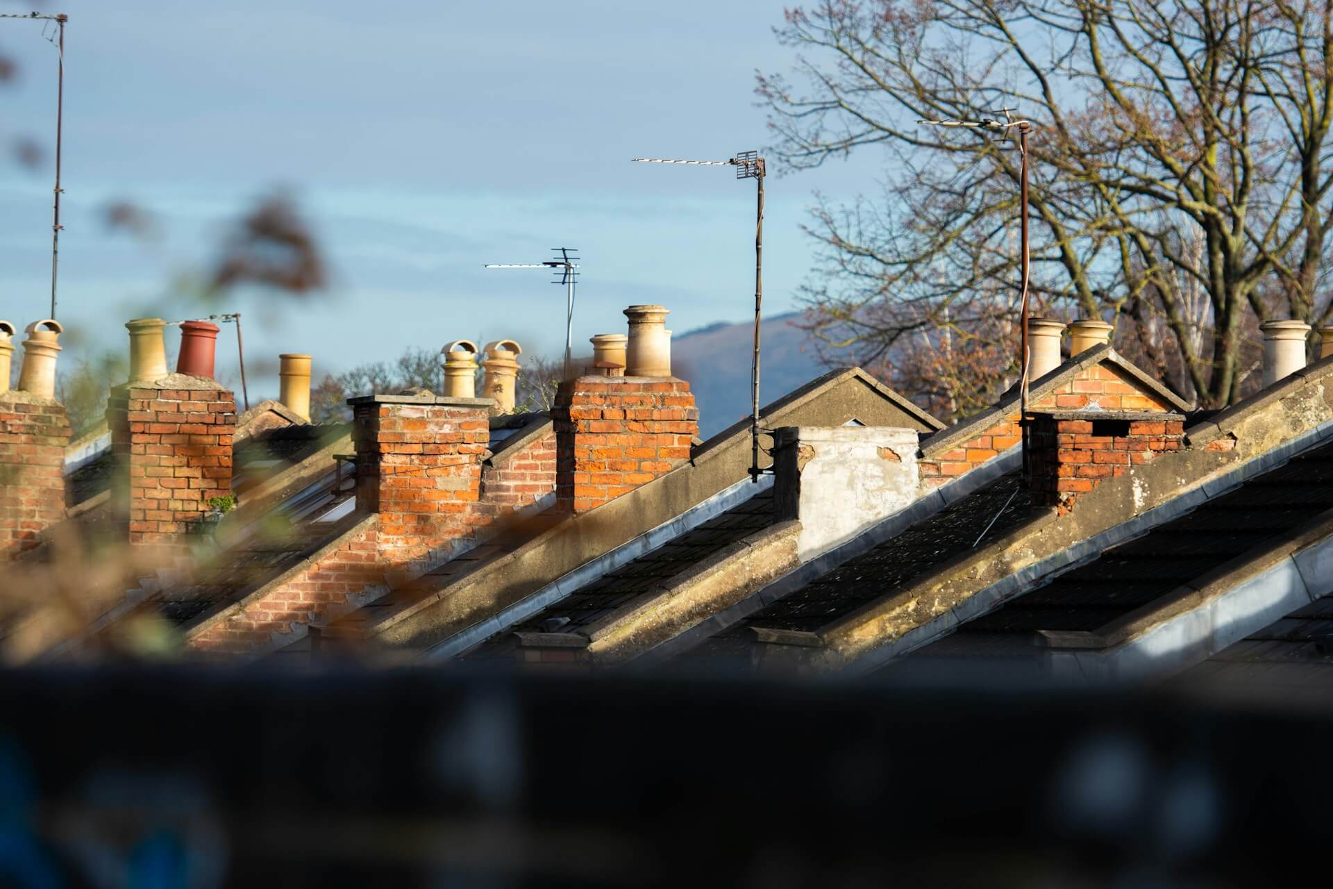 A row of chimneys on top of a brick building. Image by Unsplash