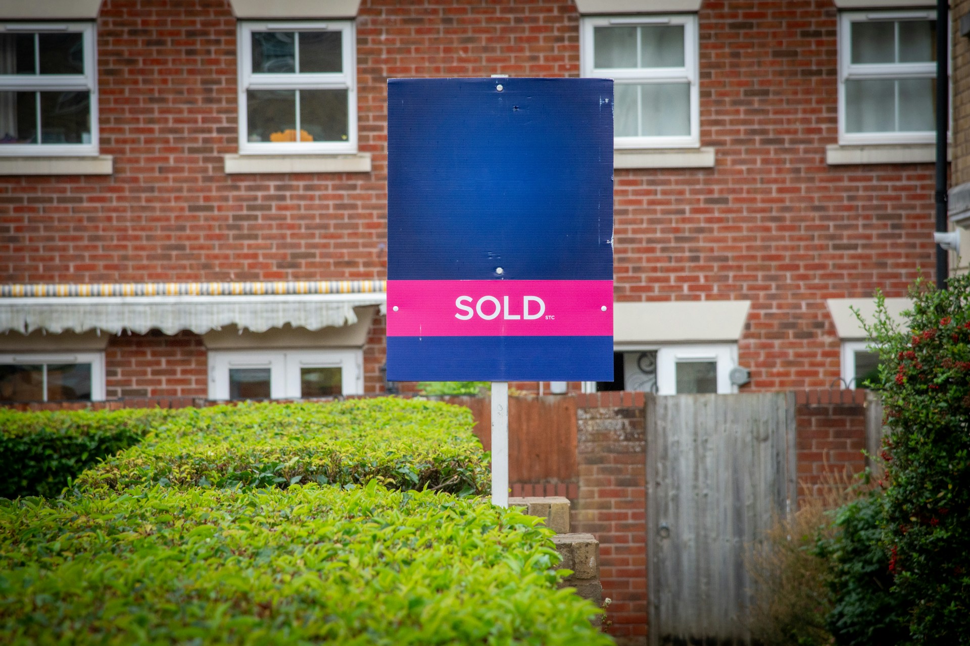 Sold sign in front of a brick house.Image by Unsplash