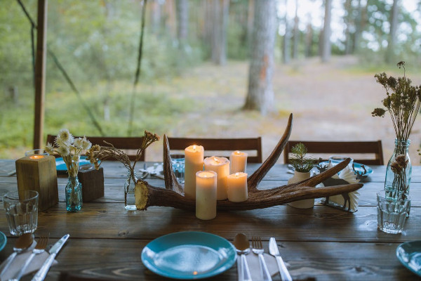 White candles on brown wooden table