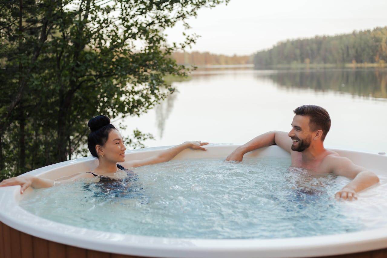 2 people in a hot tub. Image by Pexels