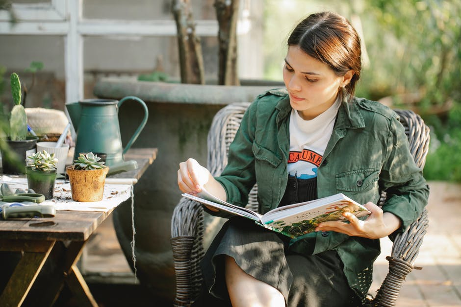 Person reading a book in the garden.